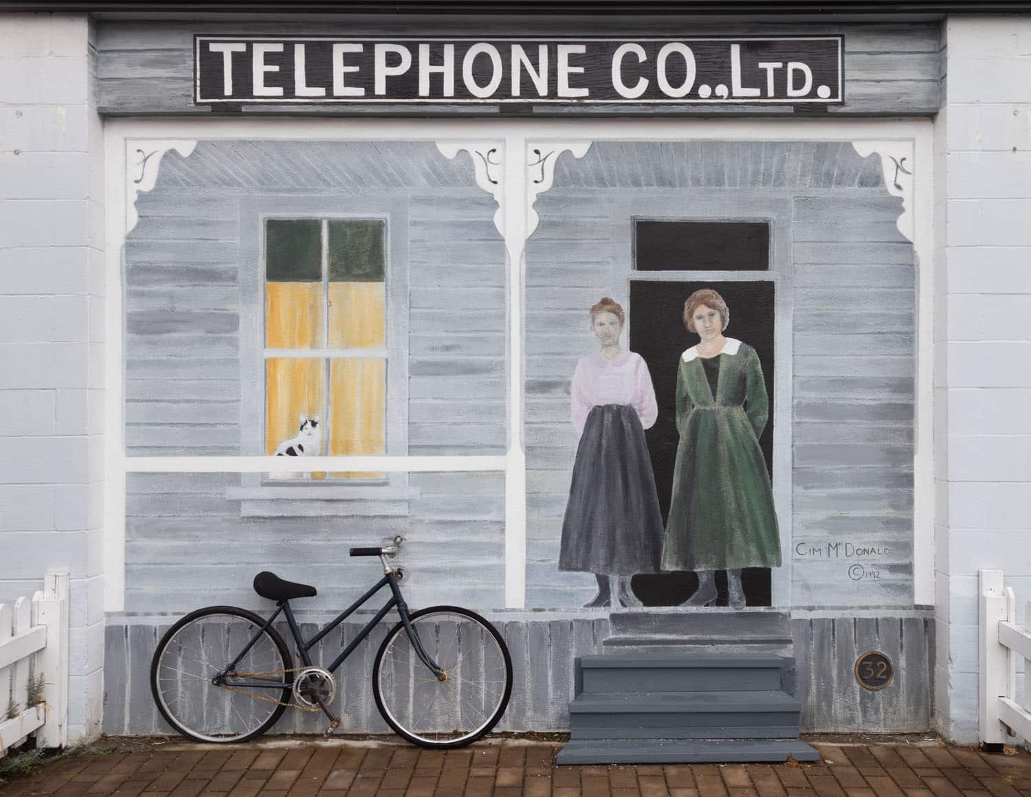 Mural of women and bicycle.