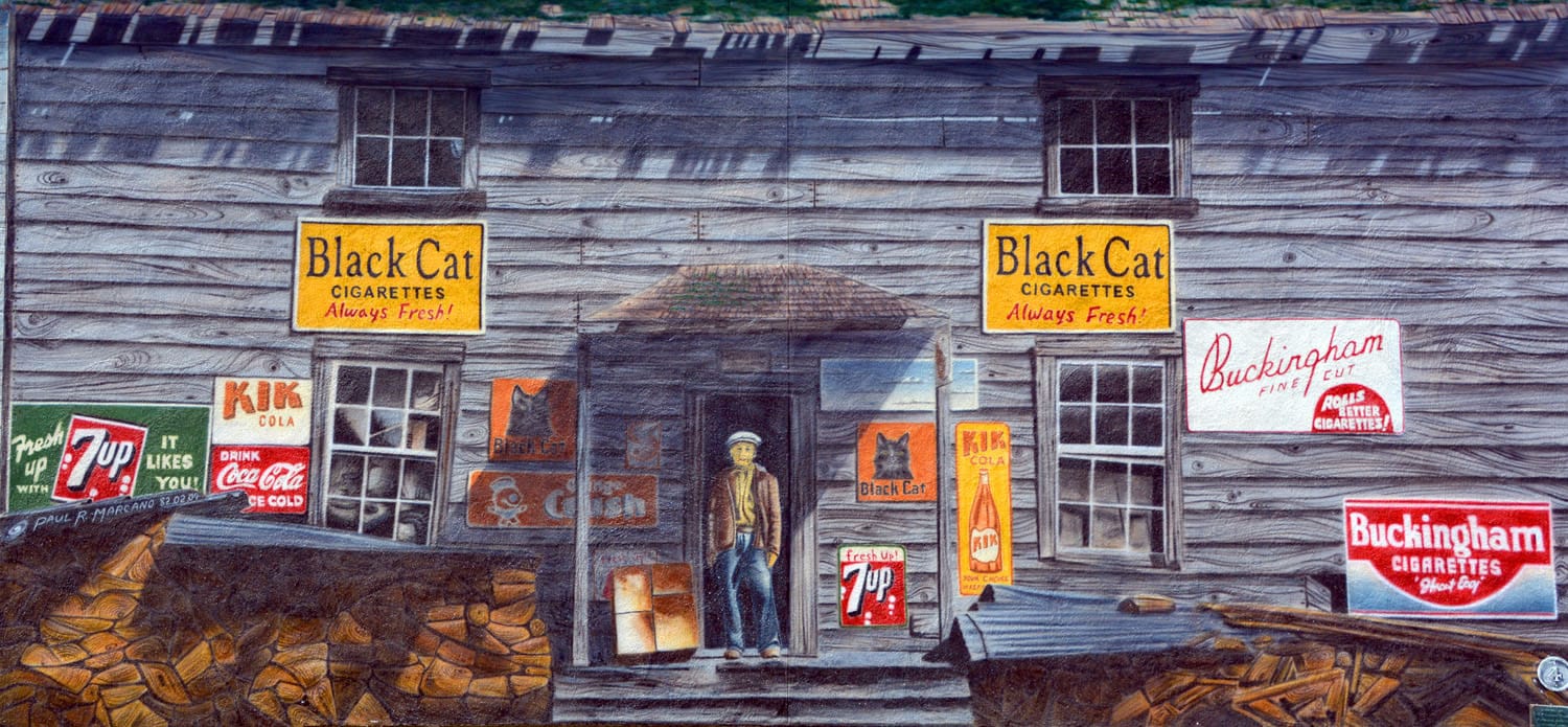 Old store with vintage advertisements outside.