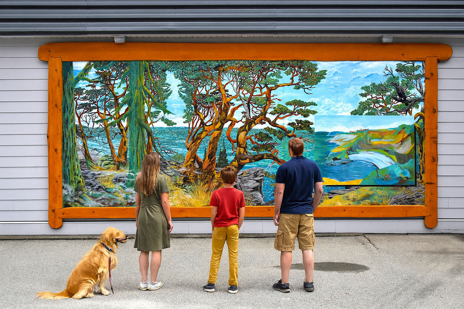 Family admiring colourful Chemainus murals.