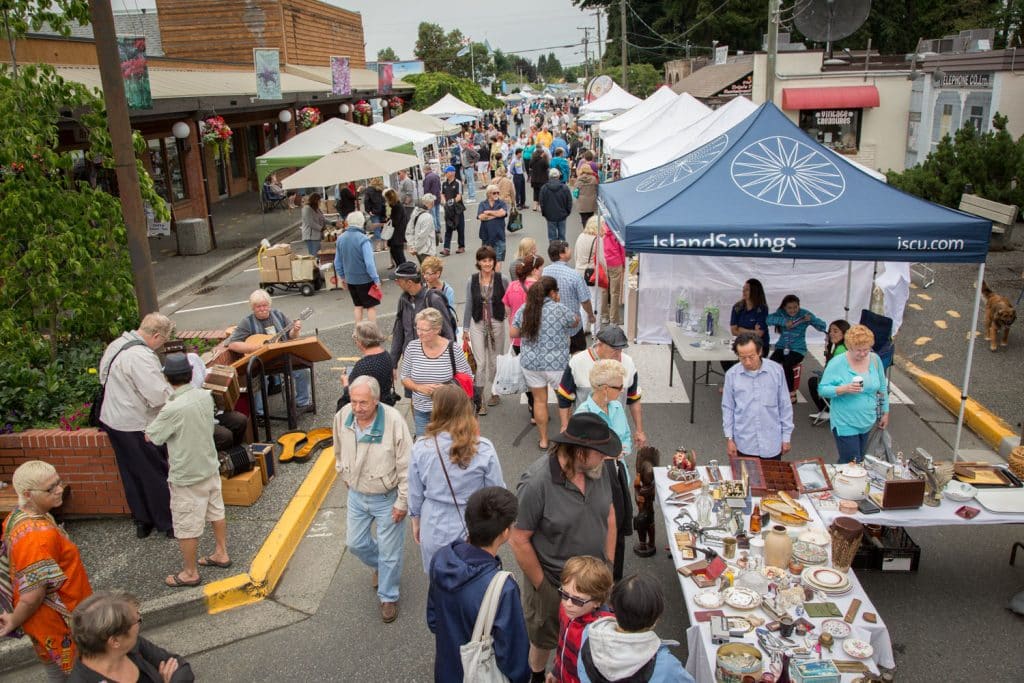 Busy outdoor market with vendors.