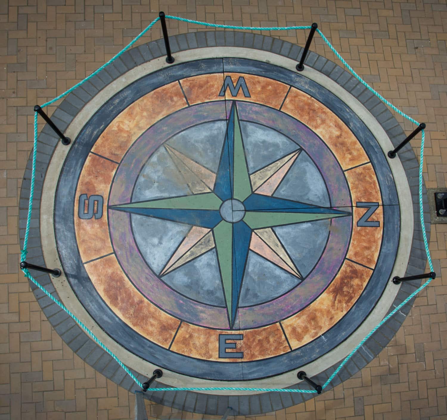 Colorful compass rose on pavement